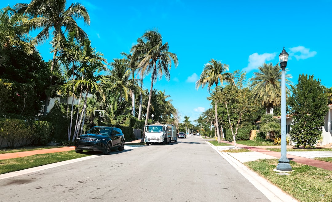 Private luxury estate entrance with palm trees in South Florida.