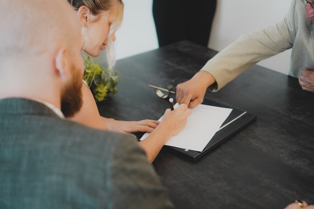 Buyer signing closing documents on a luxury off-market South Florida property purchase.