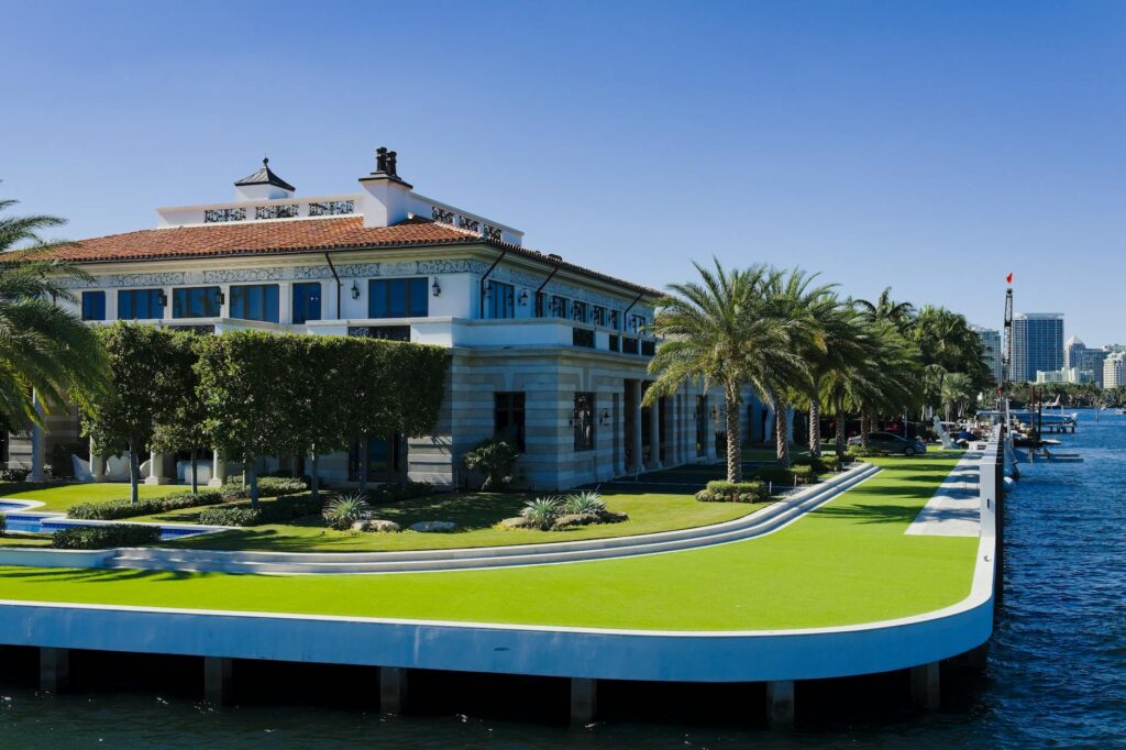 Luxury estate home exterior with evening lighting in South Florida.