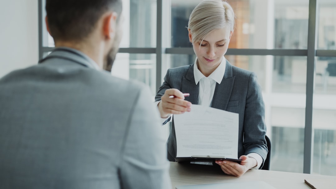 Real estate agent reviewing buyer qualification documents for a luxury property private sale.