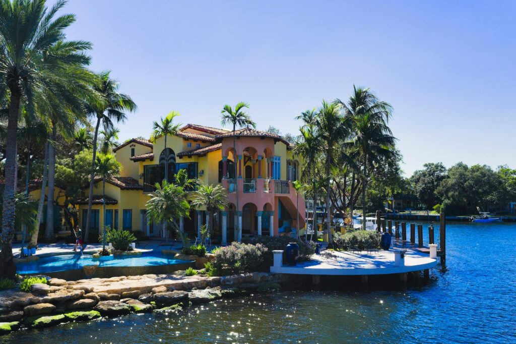 Aerial view of a luxury waterfront estate in South Florida with a private dock on a canal.