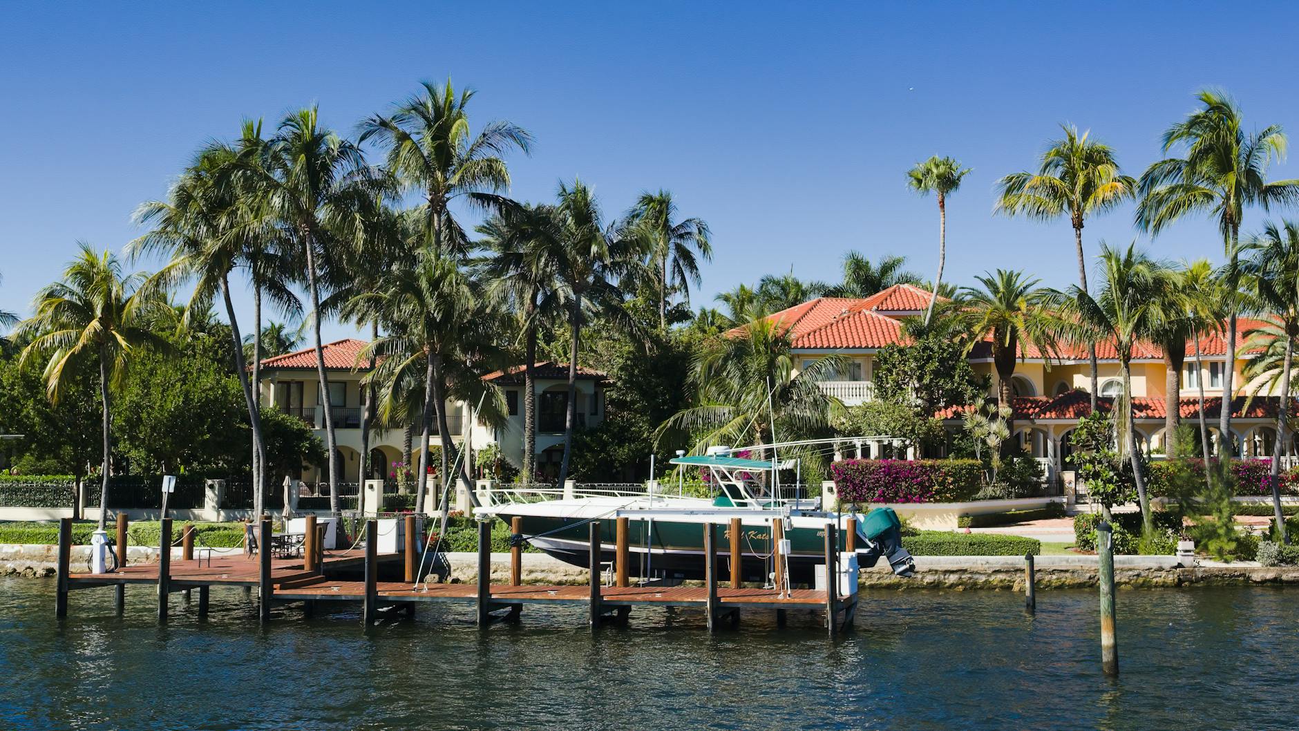 Tidal flooding on a South Florida waterfront street during a king tide event.