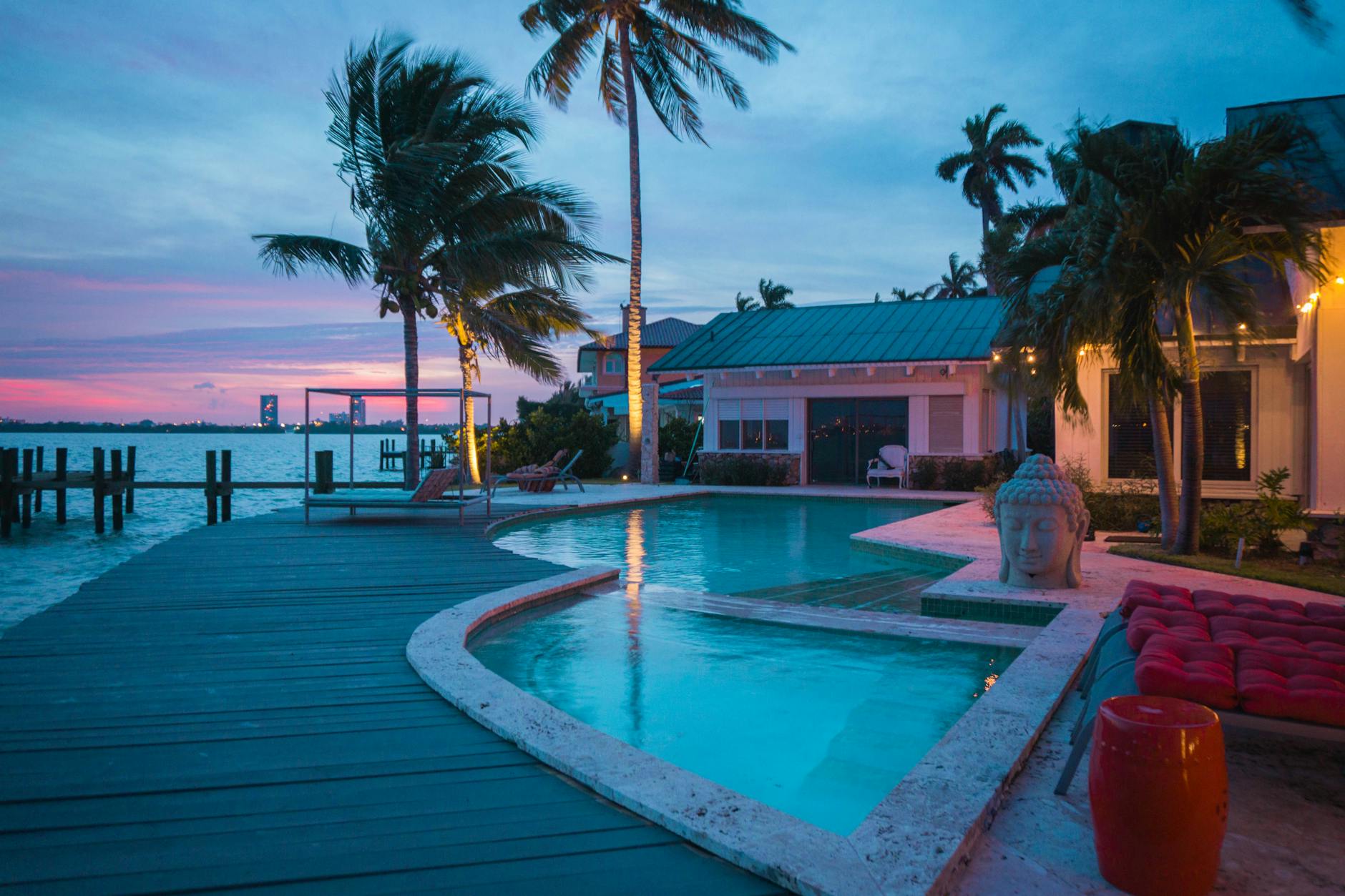 Luxury South Florida waterfront home at sunset with private dock, representing the premier waterfront real estate market.
