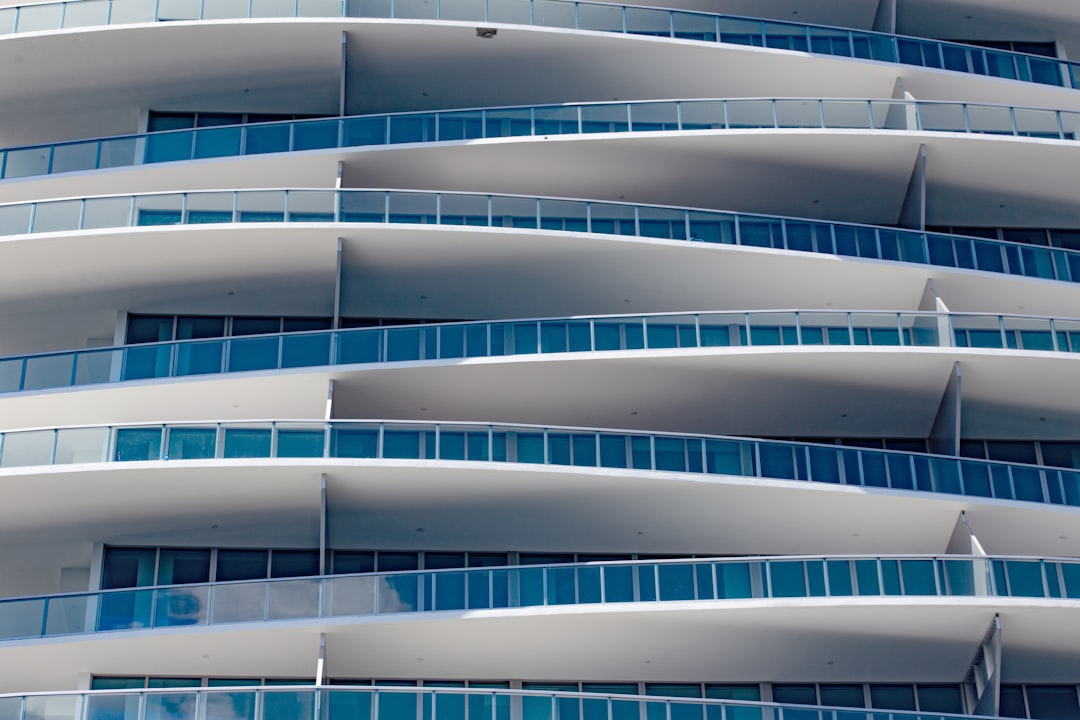 Licensed structural engineer inspecting a Florida condominium building exterior for milestone inspection compliance.