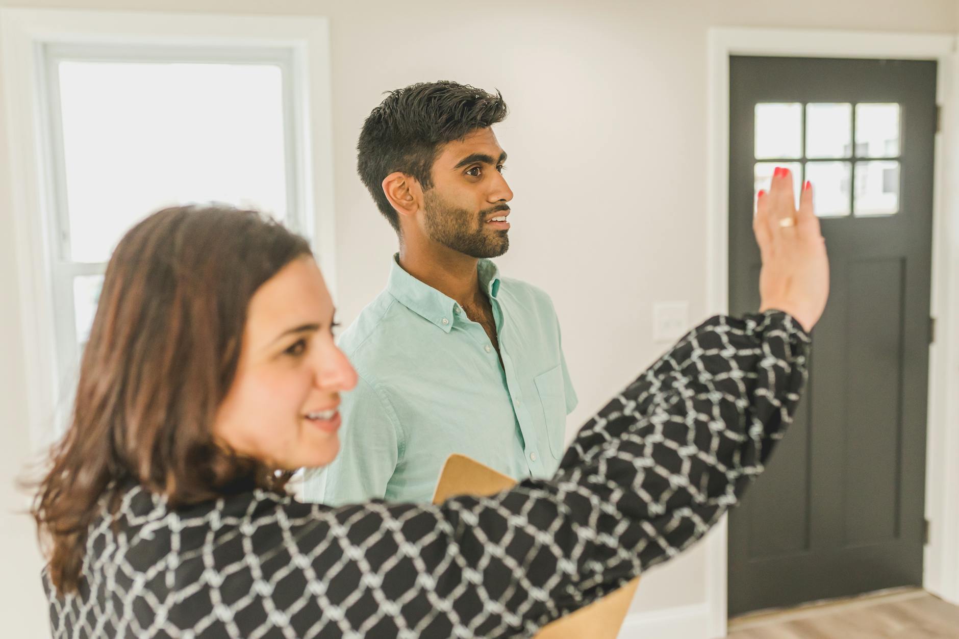 Real estate broker showing a luxury South Florida property to prospective buyers.