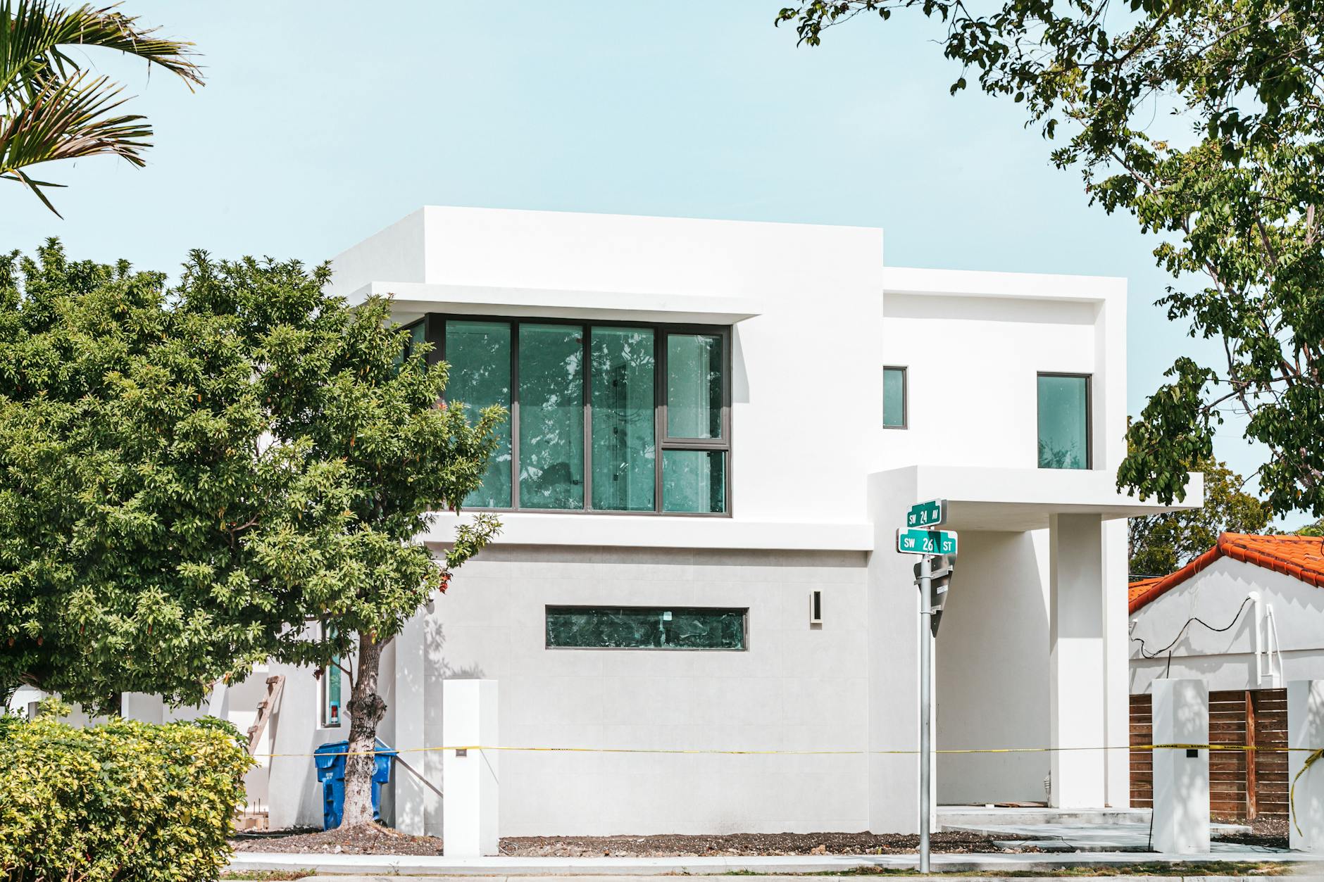 Exterior of a modern South Florida luxury home with hurricane impact windows and doors.