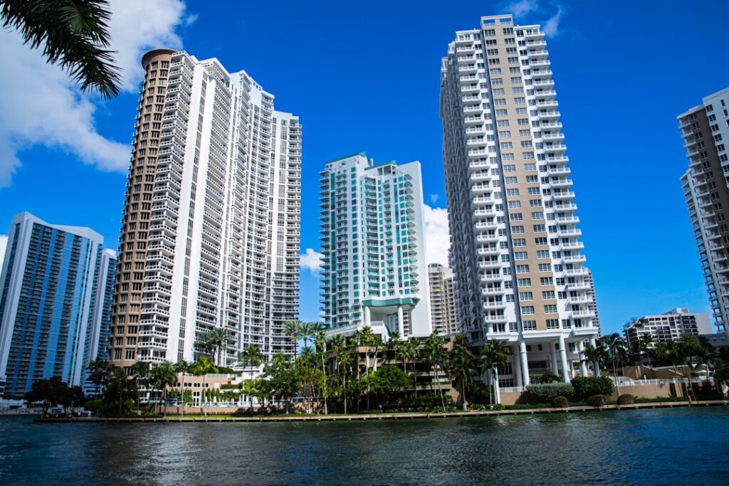 Aerial view of Miami Brickell luxury condo towers along the waterfront at sunset.