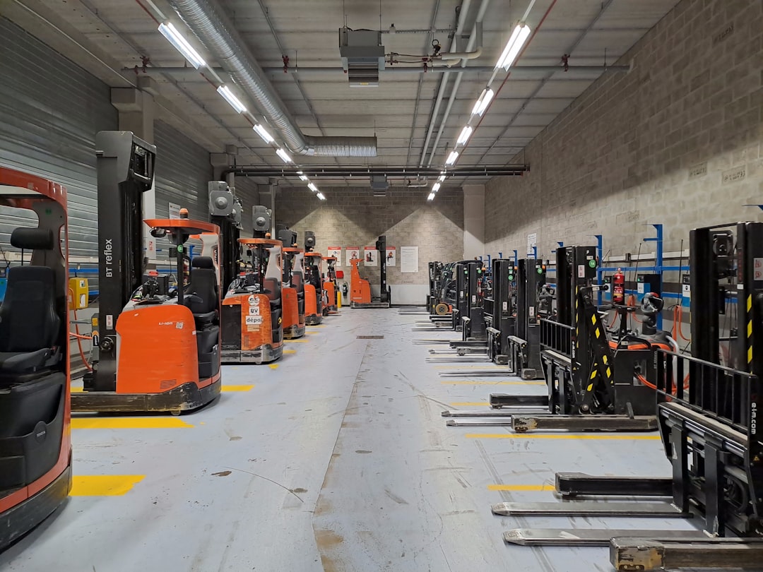 Workers and forklifts operating inside a large warehouse distribution center.