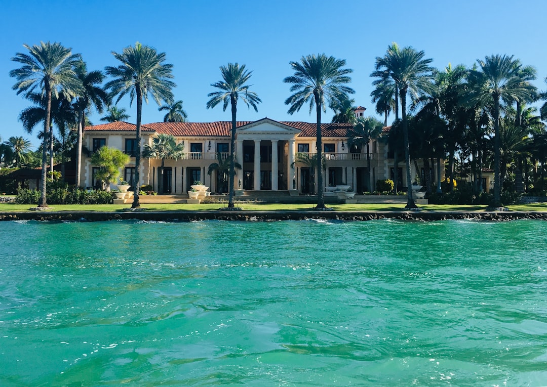 Luxury oceanfront estate on Palm Beach Island with private pool and manicured grounds.