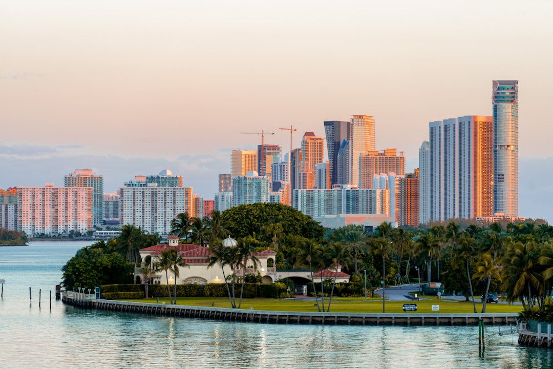 Luxury home buyer signing closing documents at a real estate transaction table in Florida.