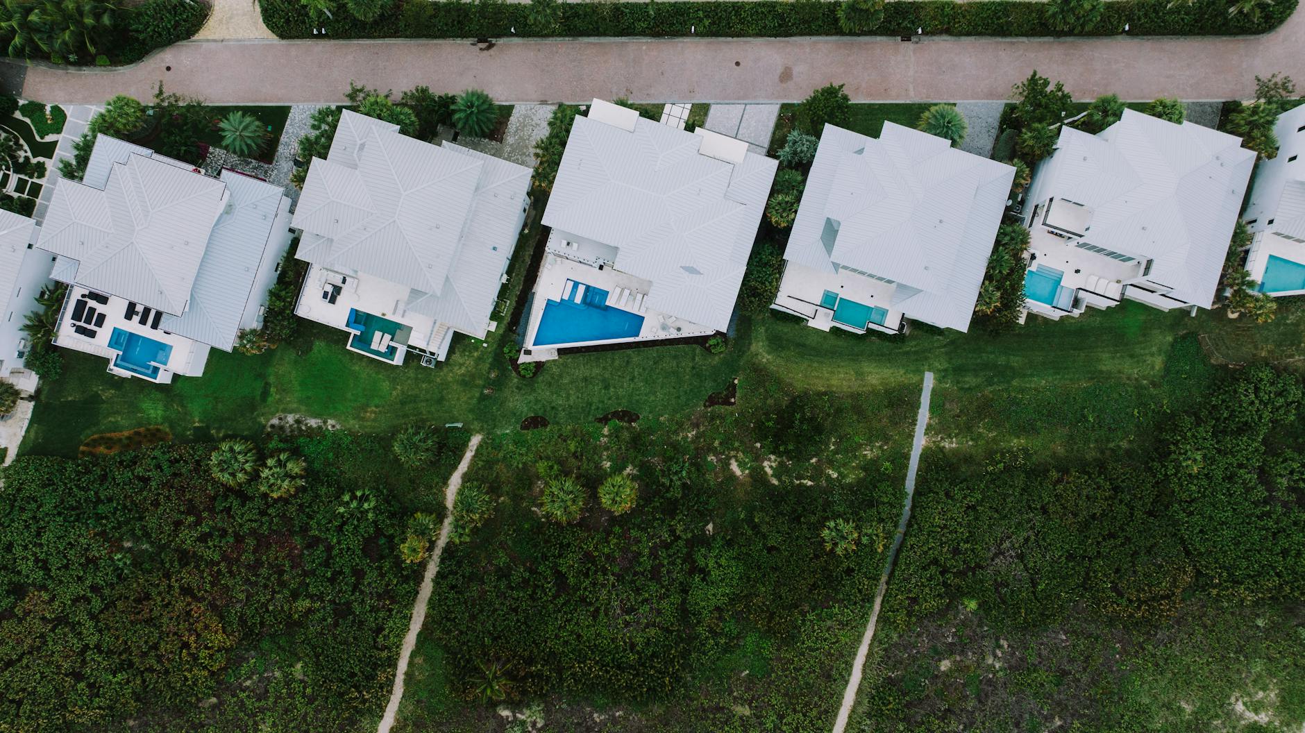 Aerial view of a luxury waterfront estate with private pool in South Florida.