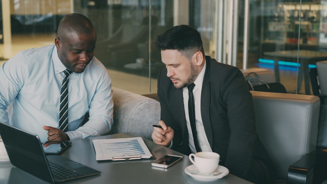 Financial advisor reviewing investment portfolio strategy with a high-net-worth client.