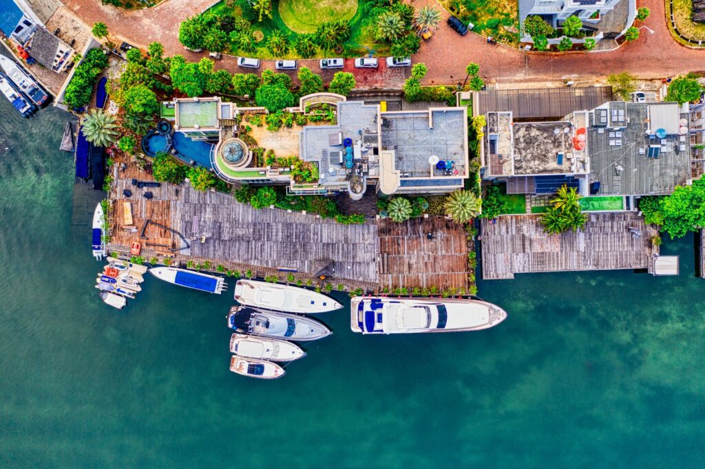 Aerial view of a luxury waterfront estate in South Florida with private pool and dock.