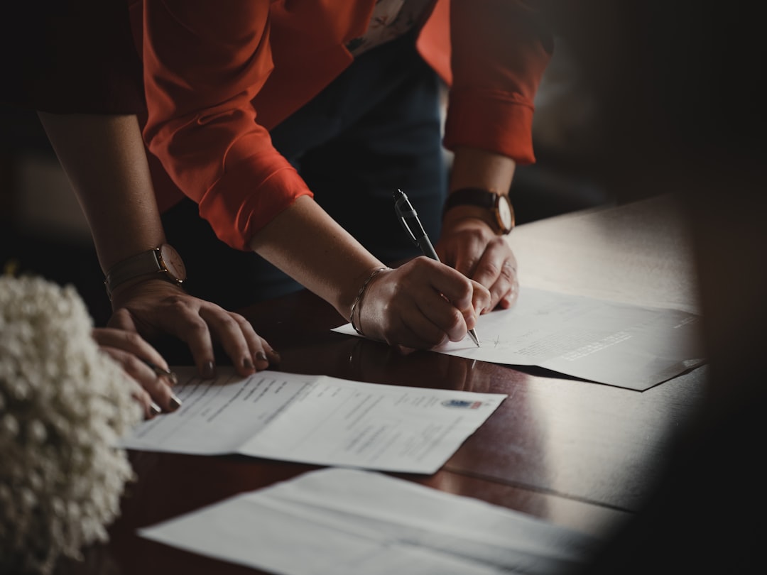 Luxury home buyer reviewing and signing a real estate purchase contract.