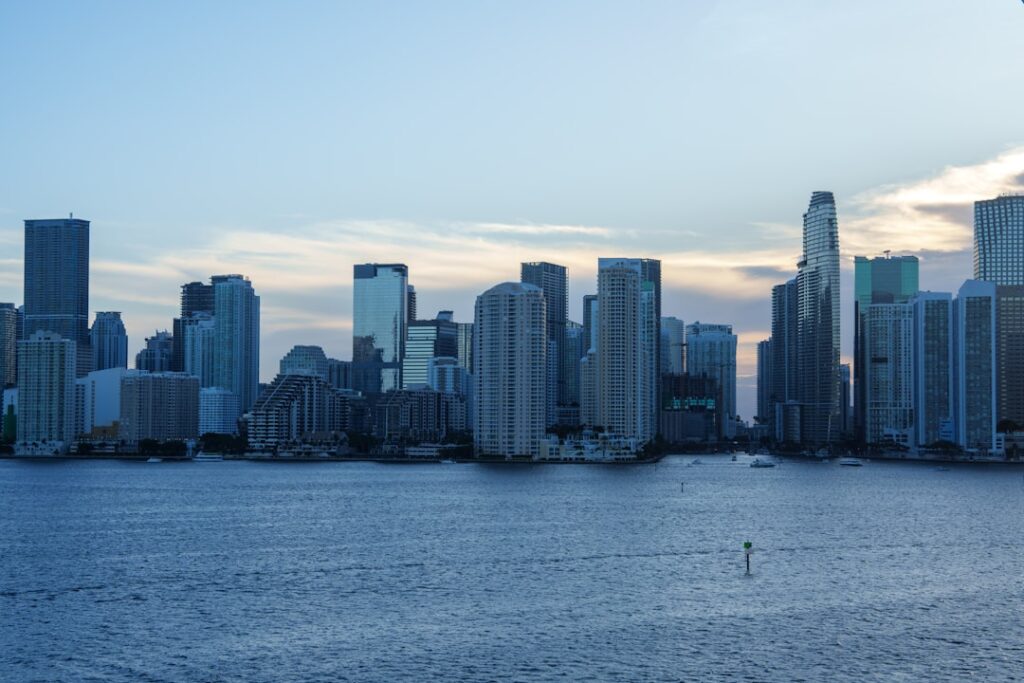 Aerial view of South Florida skyline with luxury waterfront properties and high-rise developments.