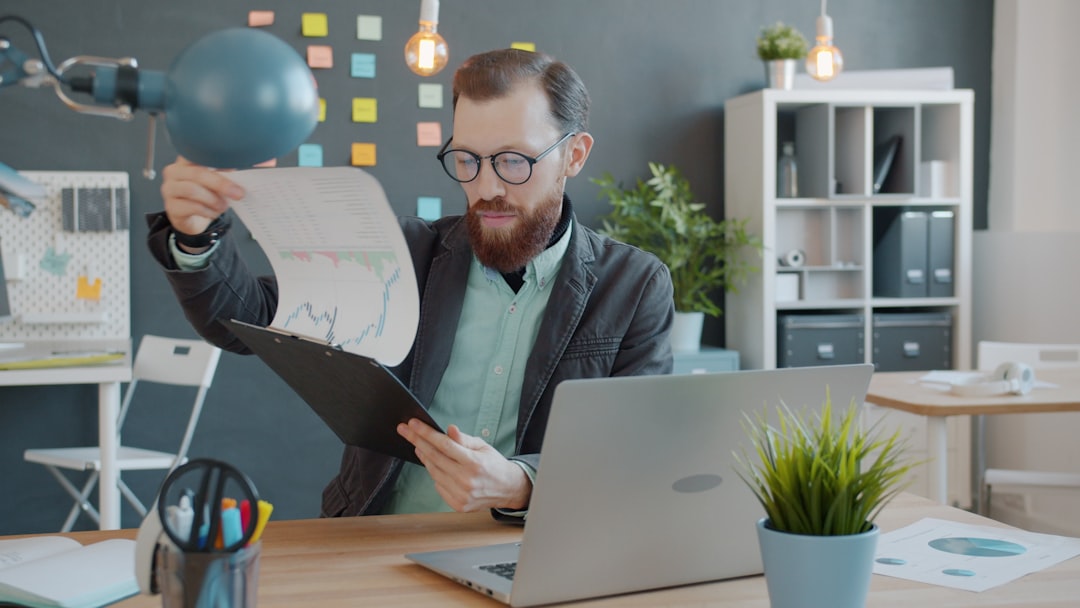 Real estate investor reviewing Florida portfolio strategy documents at office desk.