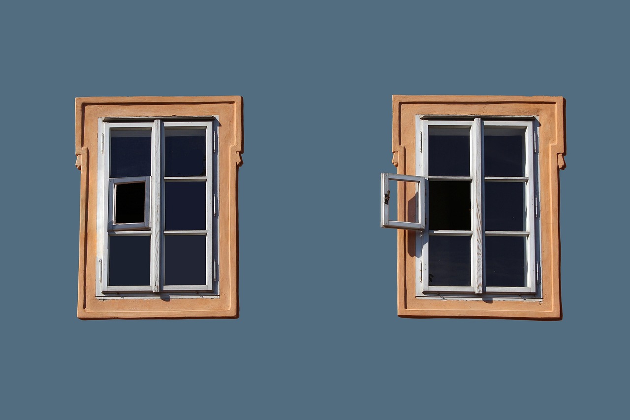 Impact-rated windows and hurricane protection on a luxury South Florida home exterior.