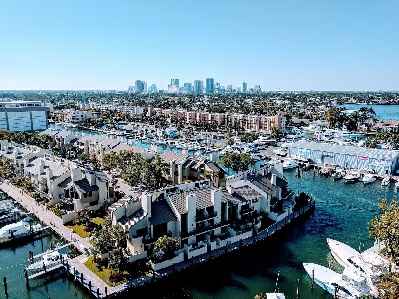 Luxury waterfront estate on a Fort Lauderdale canal with private boat dock and palm trees.