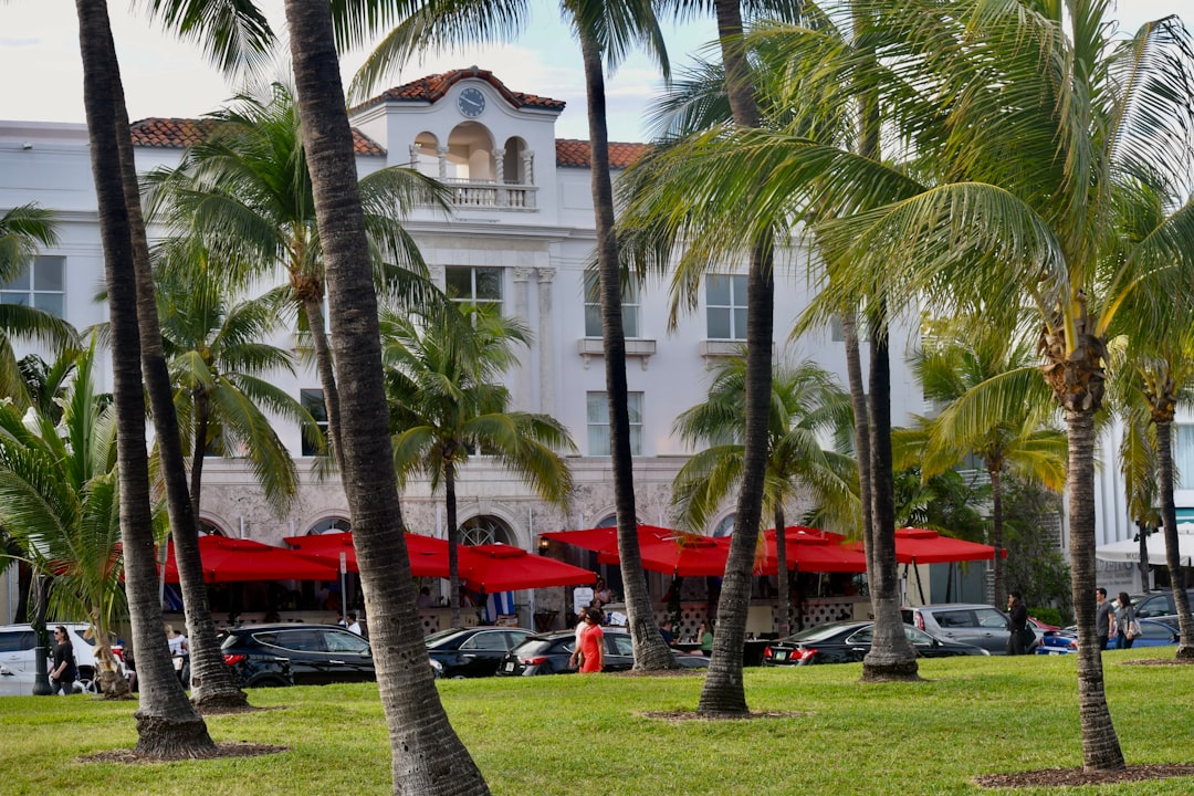 Luxury oceanfront estate with pool and palm trees on Miami Beach, Florida.