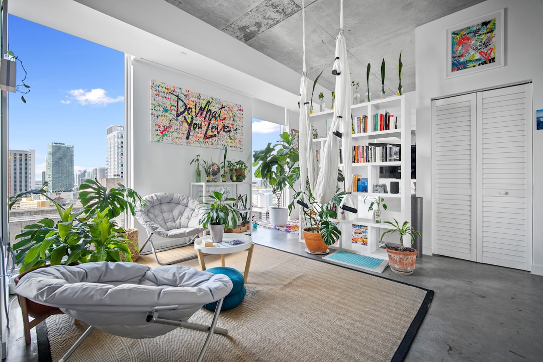 Interior of a Miami luxury condo with floor-to-ceiling windows and panoramic water views.