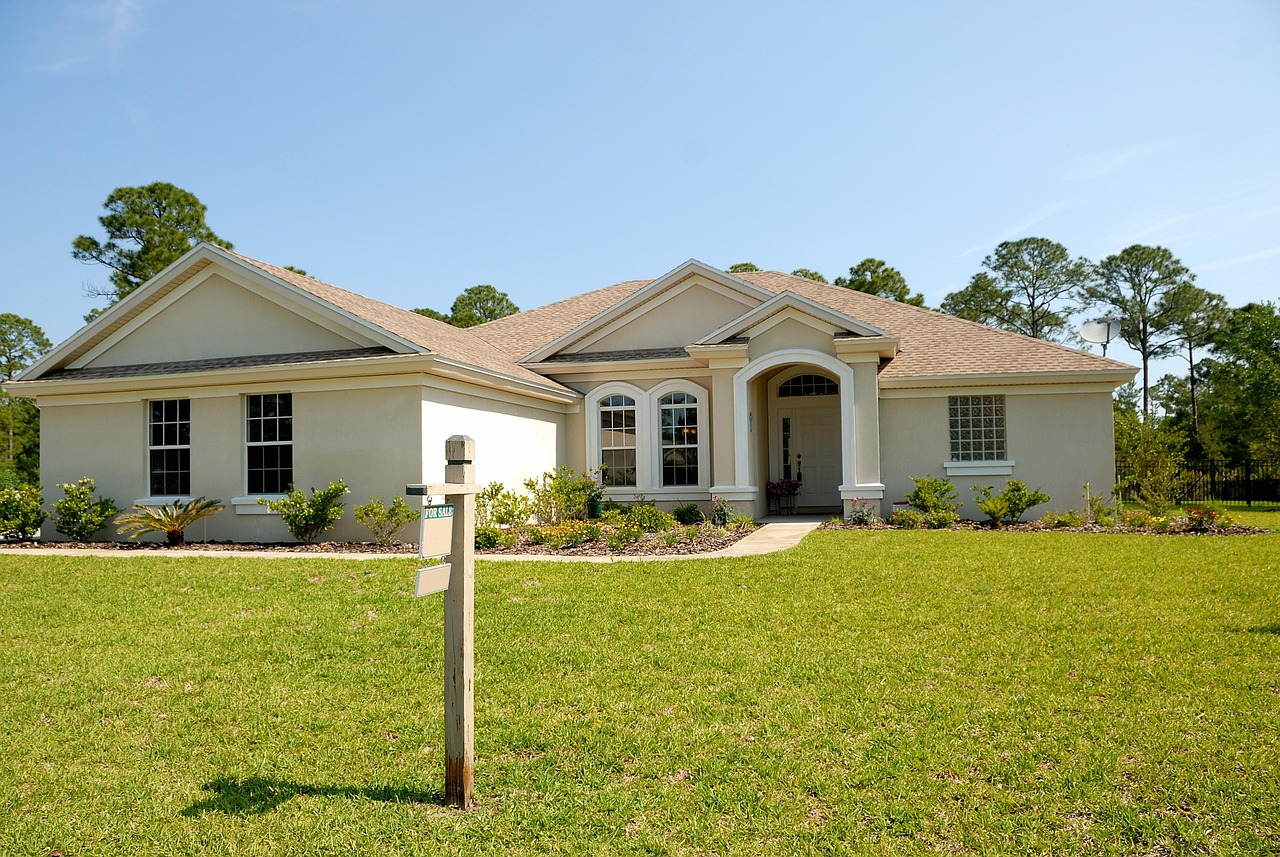 Luxury waterfront estate listed for sale in Naples, Florida with lush landscaping.