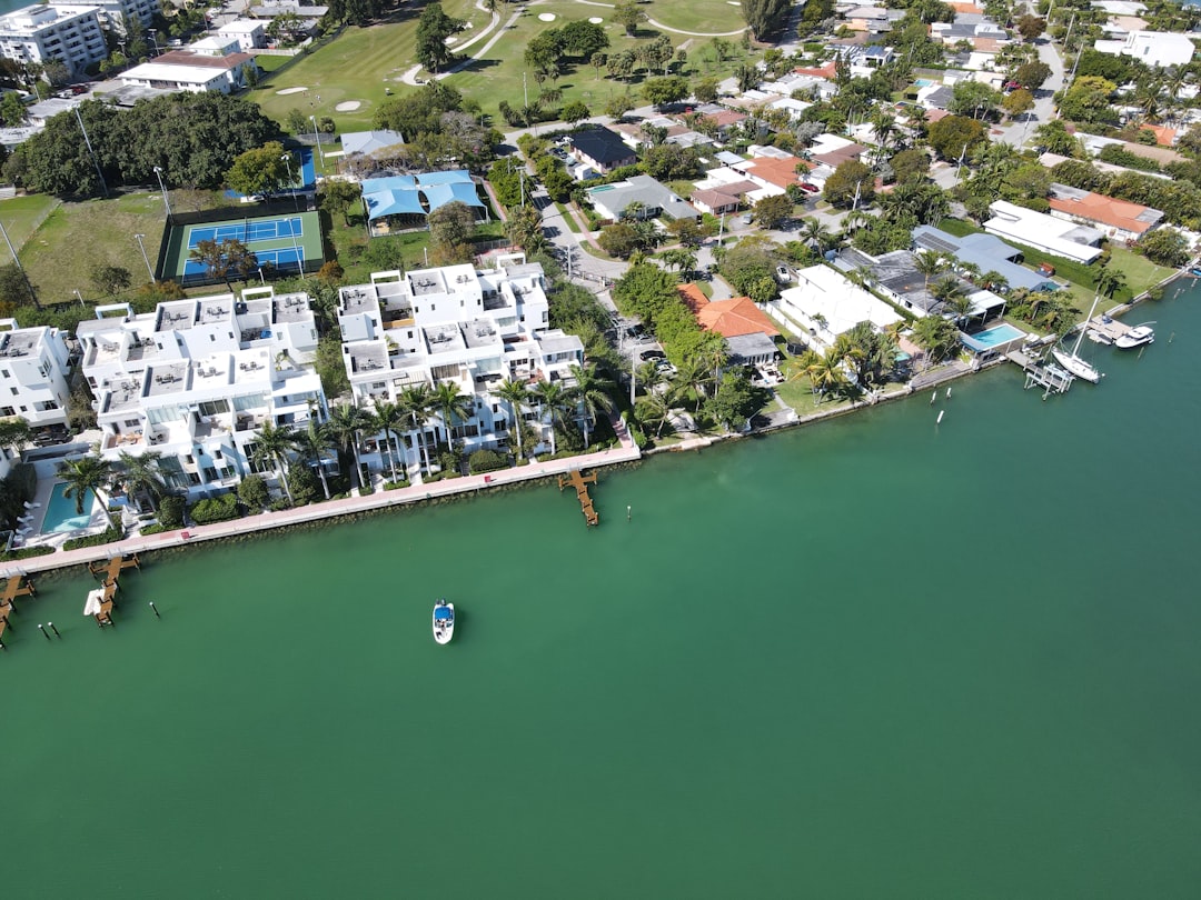 Inspector assessing a large luxury estate exterior with swimming pool in Florida.