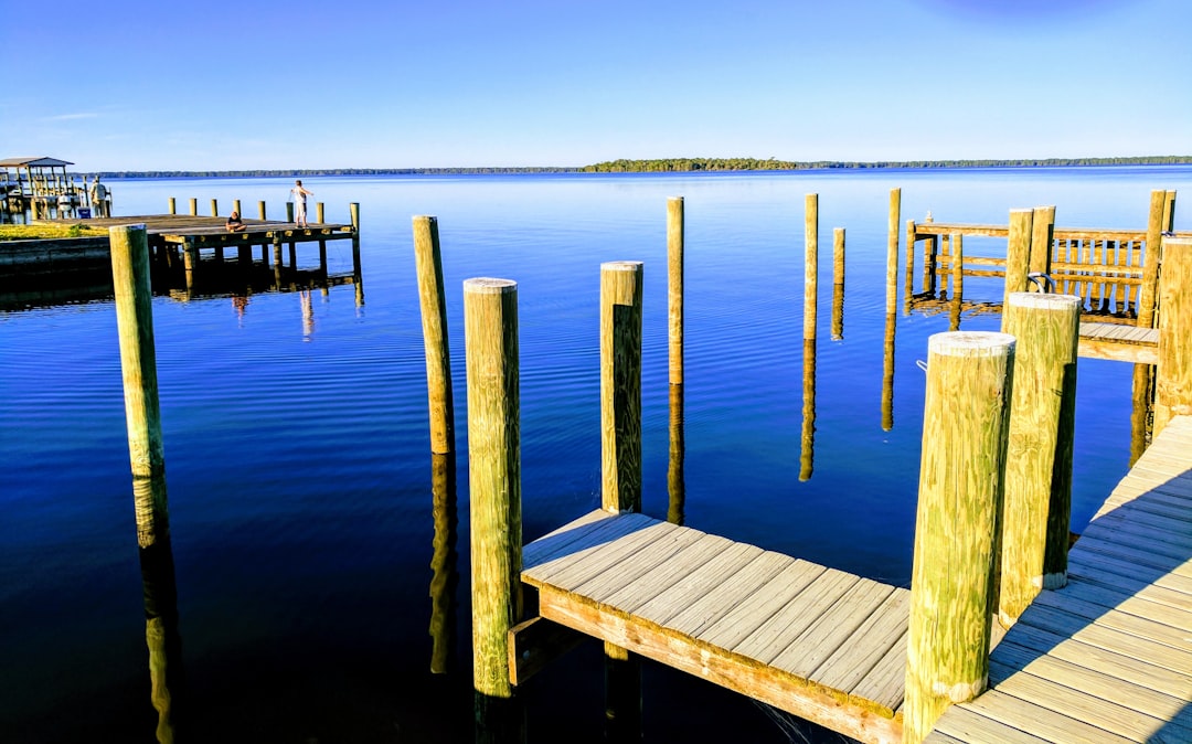 Buyer inspecting a private dock and seawall on a Florida waterfront luxury property.