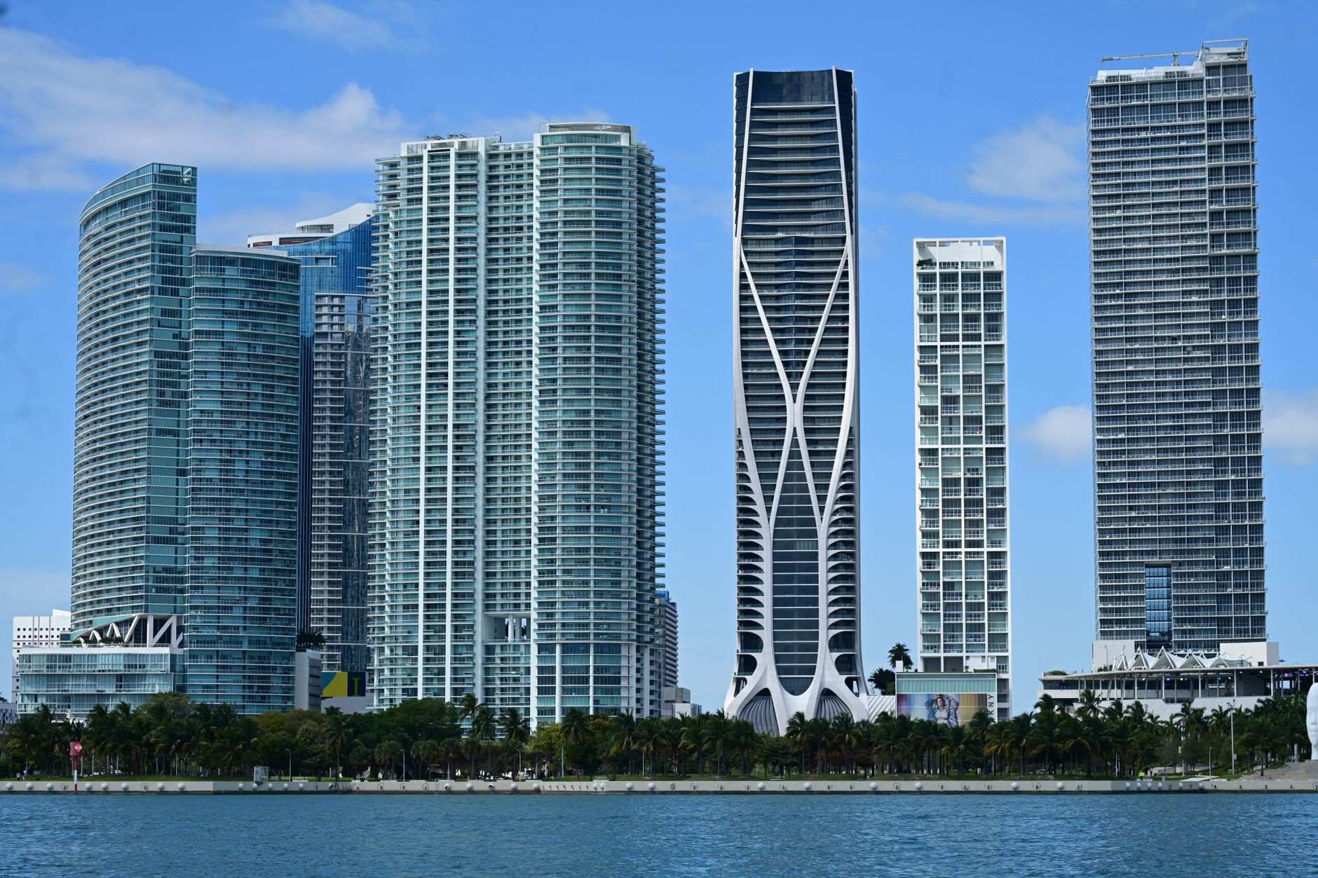Aerial view of Miami's Brickell commercial district with high-rise office towers and South Florida skyline.