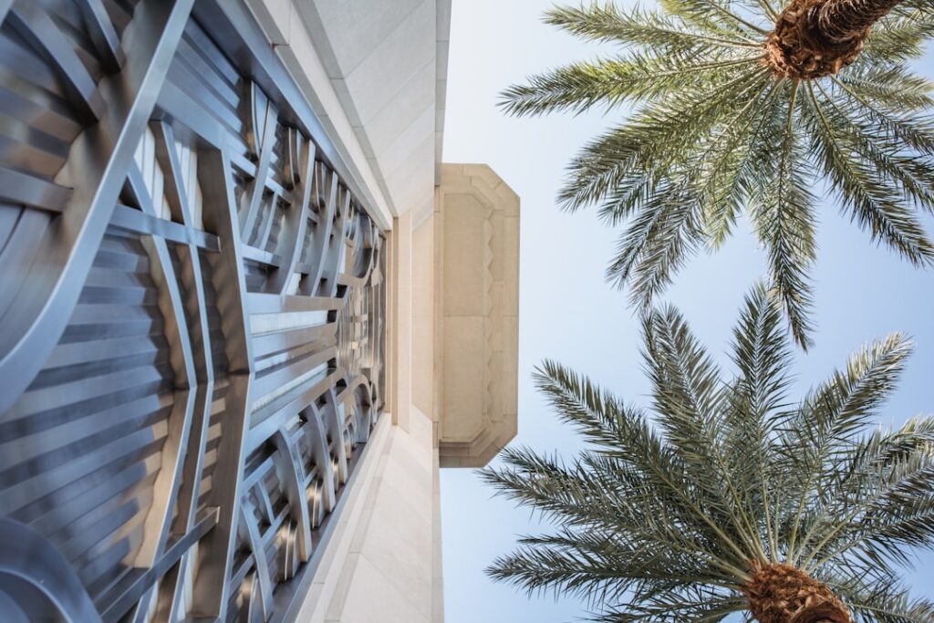 Luxury gated community entrance in South Florida with guard gate and palm trees.