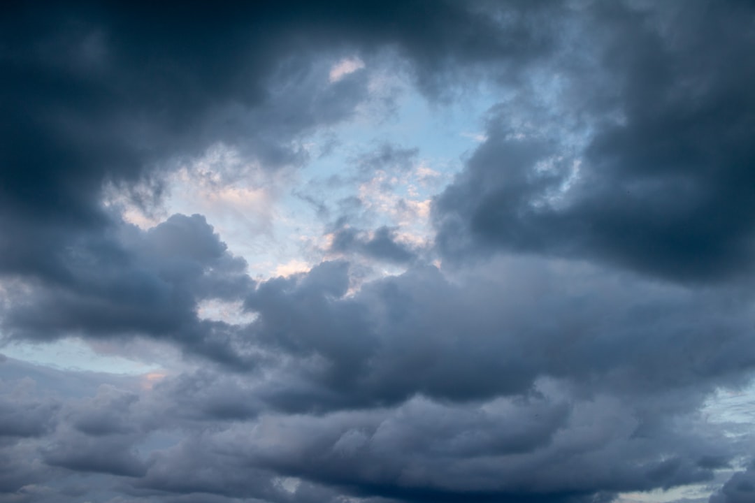 Storm clouds gathering over the South Florida coastline near luxury waterfront homes