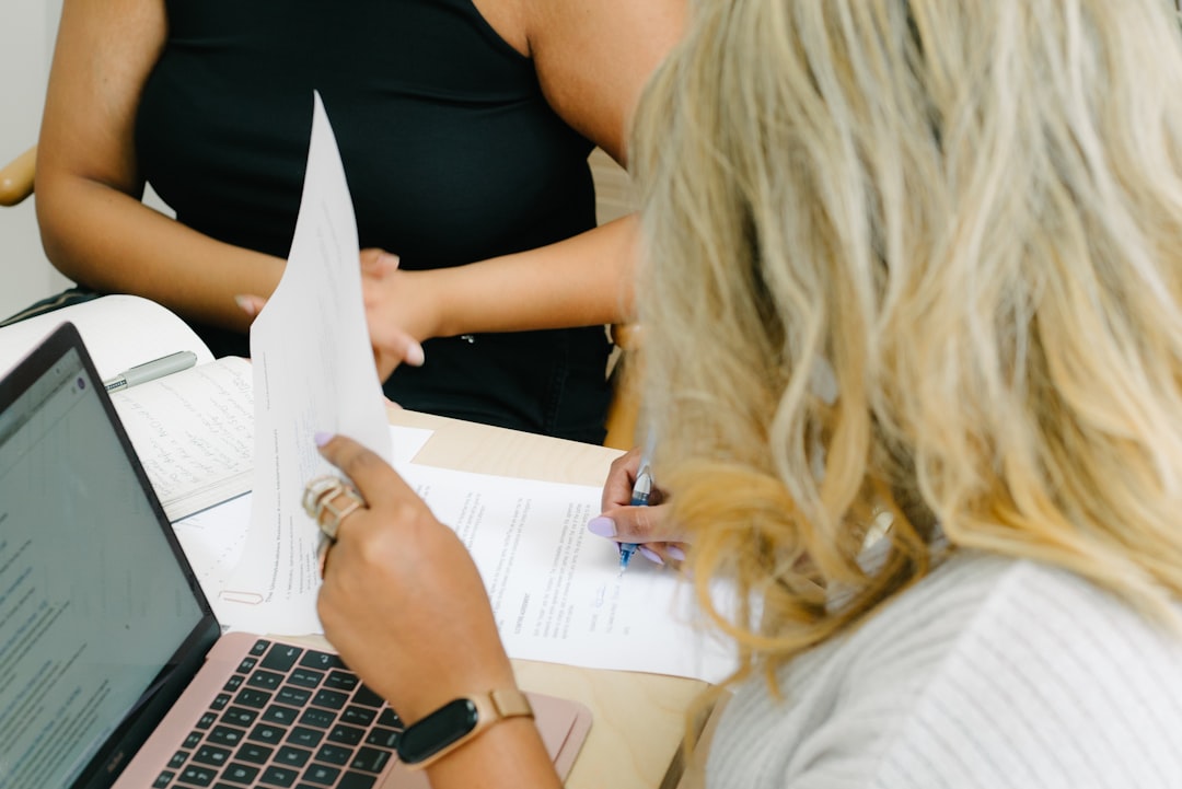 Lender reviewing jumbo mortgage loan limits and paperwork with luxury home buyers