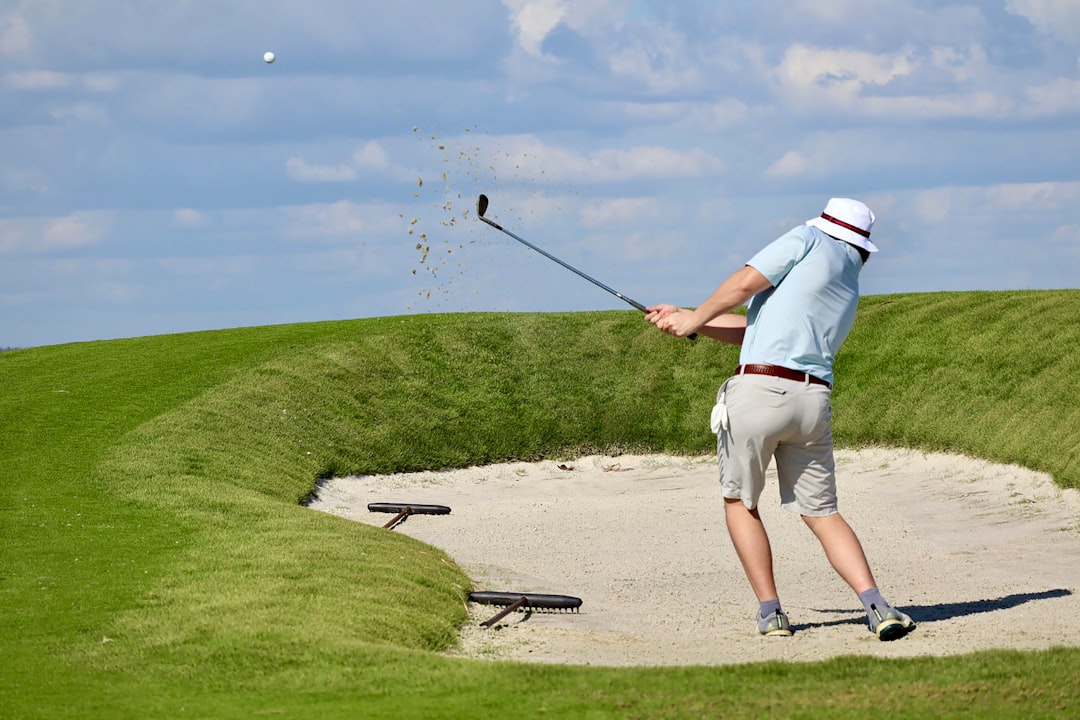 Golfer teeing off on a scenic South Florida golf course