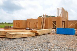 New luxury home under construction beside a finished waterfront estate in Fort Lauderdale, Florida