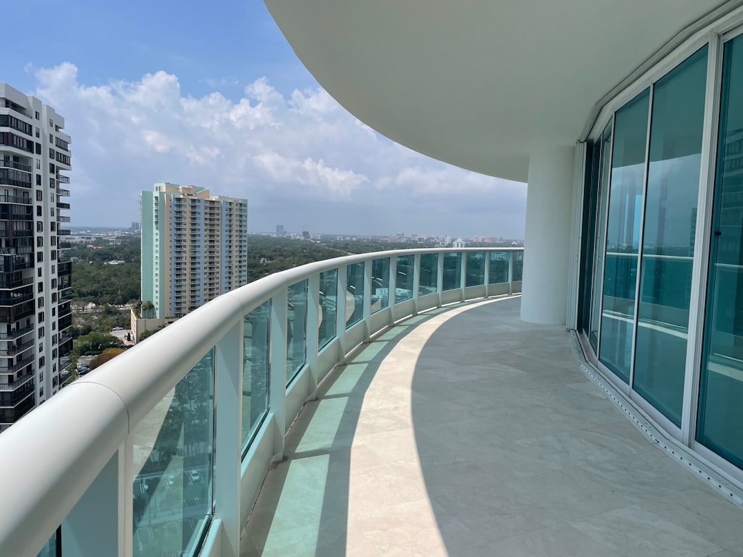 Rooftop pool deck at a luxury Miami Beach condo building overlooking the skyline.