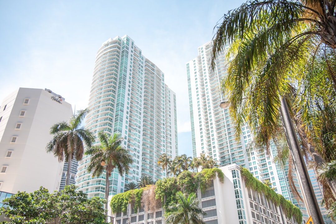 A broker showing a luxury Miami Beach condo interior to prospective buyers.