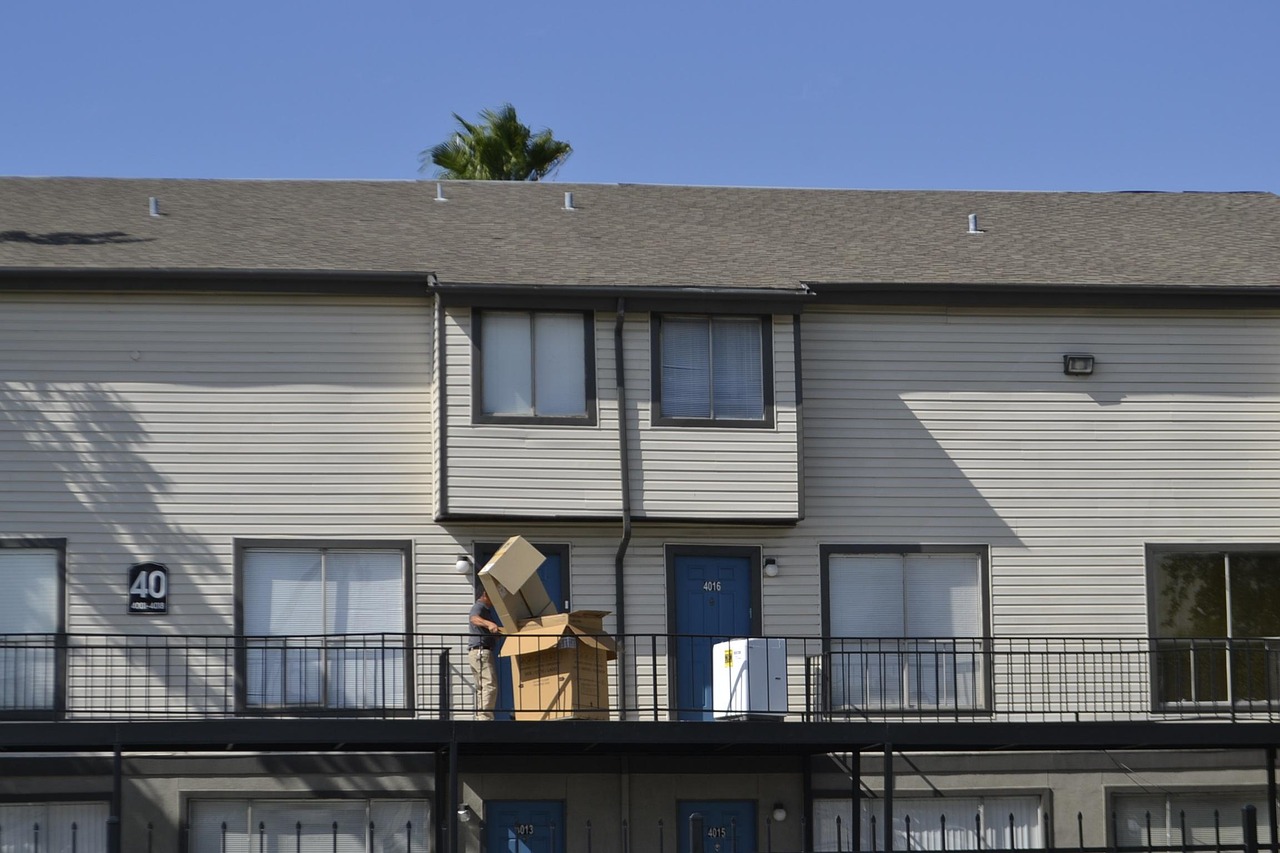 Moving truck and boxes outside a Florida apartment complex during a household relocation
