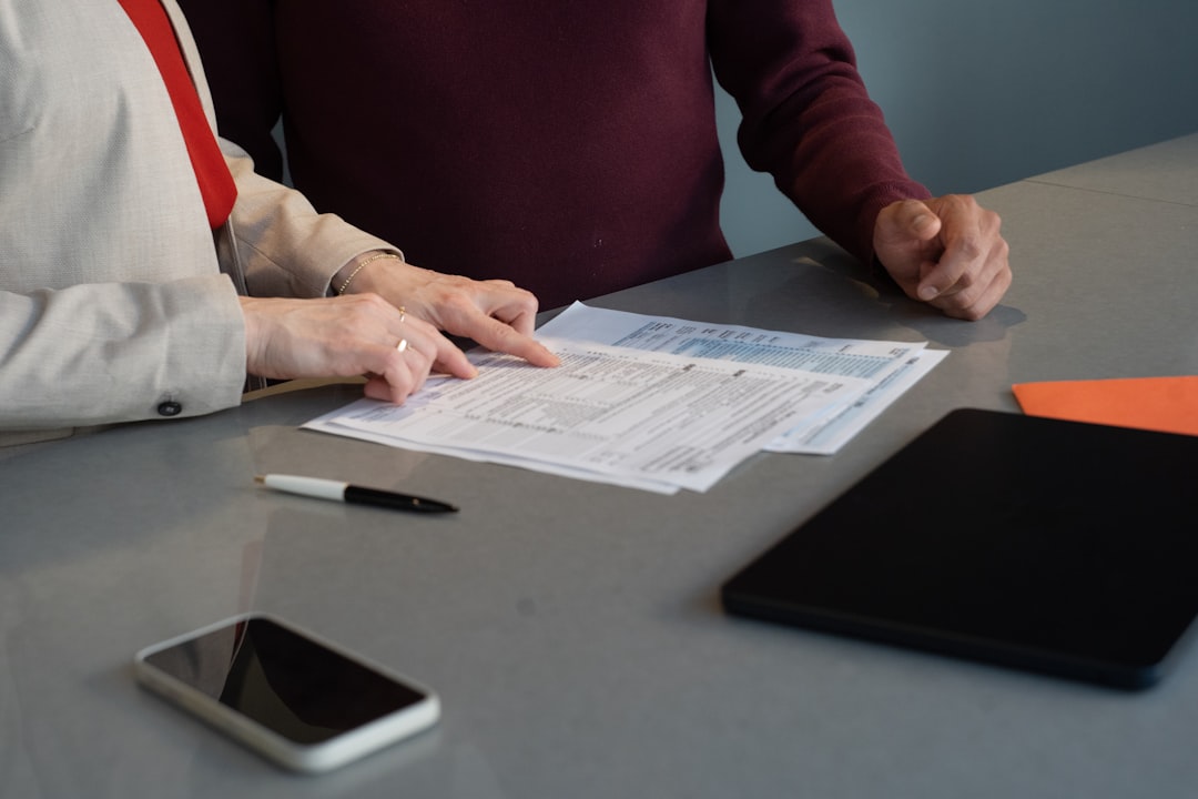 Broker and buyers reviewing closing documents for a Florida luxury condo purchase