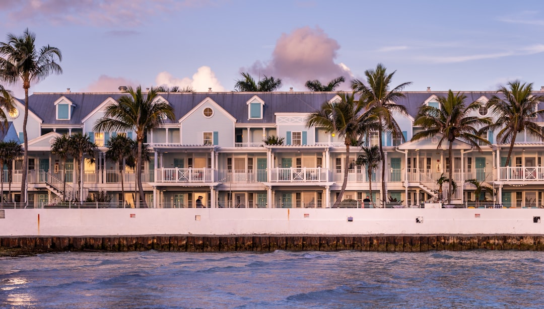 Marine construction crew installing a new concrete seawall panel along a Florida waterfront property