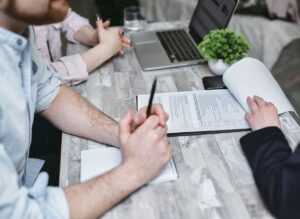 Buyers and a title agent at a closing table in a South Florida luxury home purchase