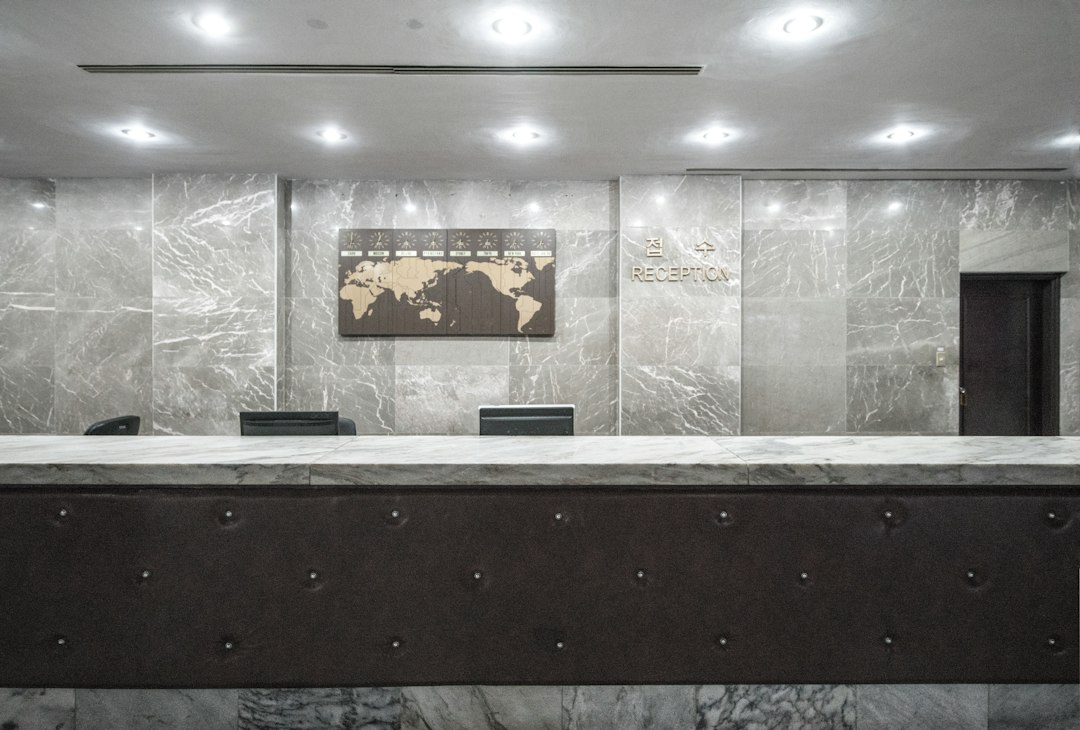Marble hotel-style lobby and concierge desk inside a Miami branded residence