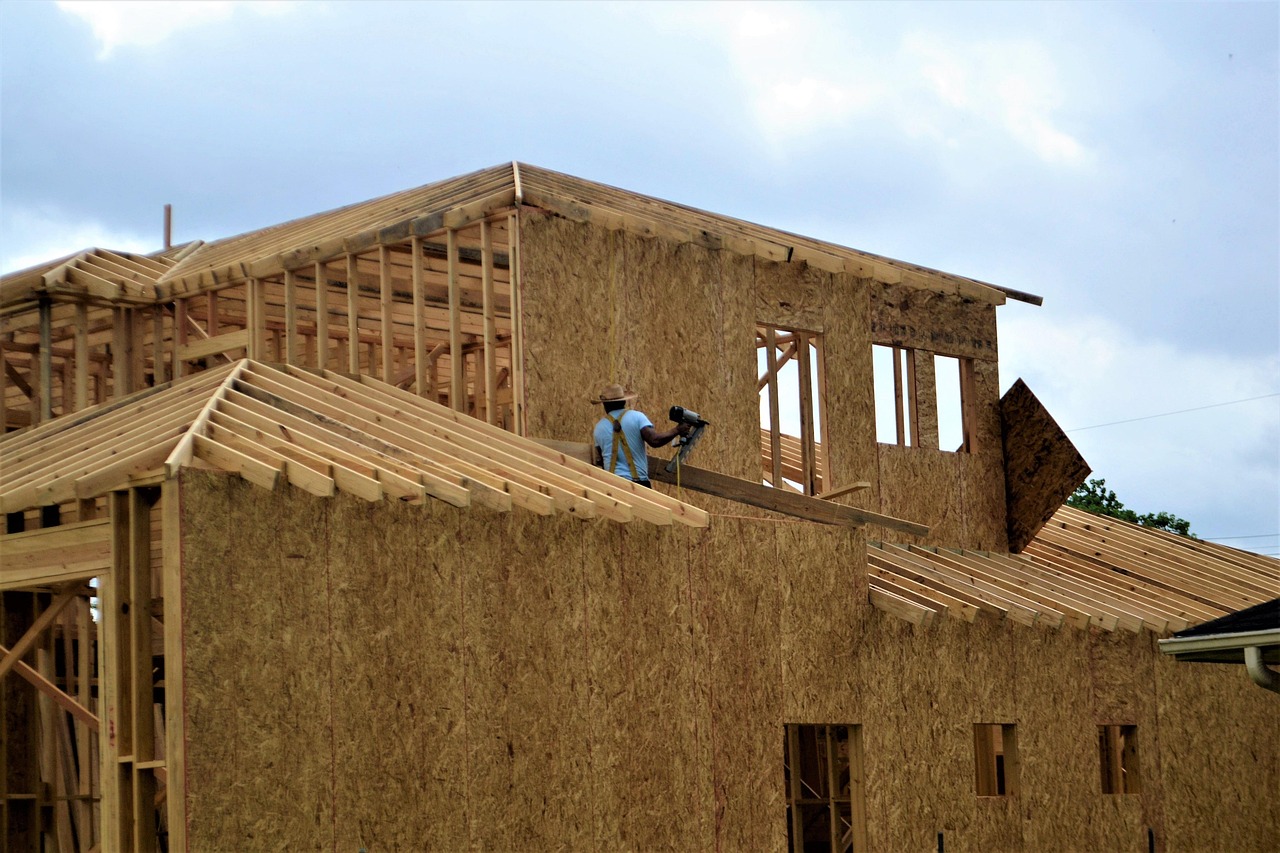 Contractor reviewing renovation plans at a luxury Florida property under construction