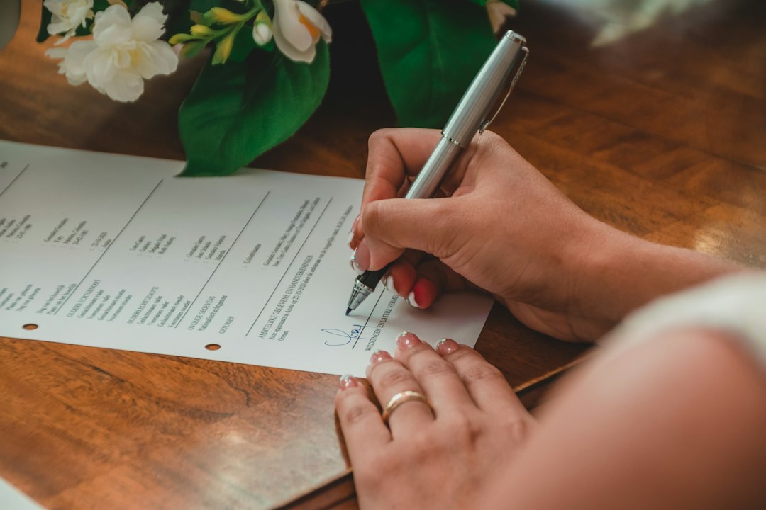 Buyer and seller signing real estate closing documents on a luxury home purchase