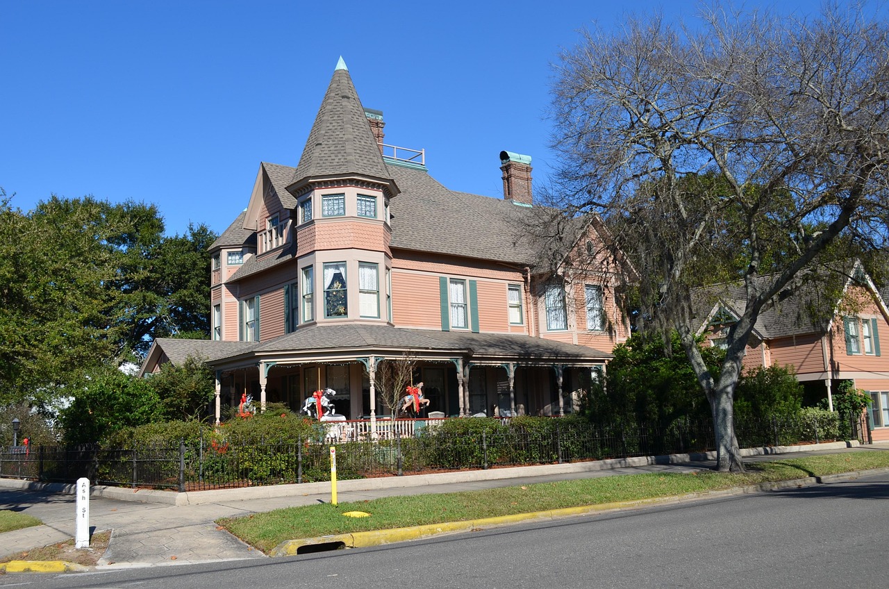 Home inspector examining the exterior of a luxury Florida house during due diligence