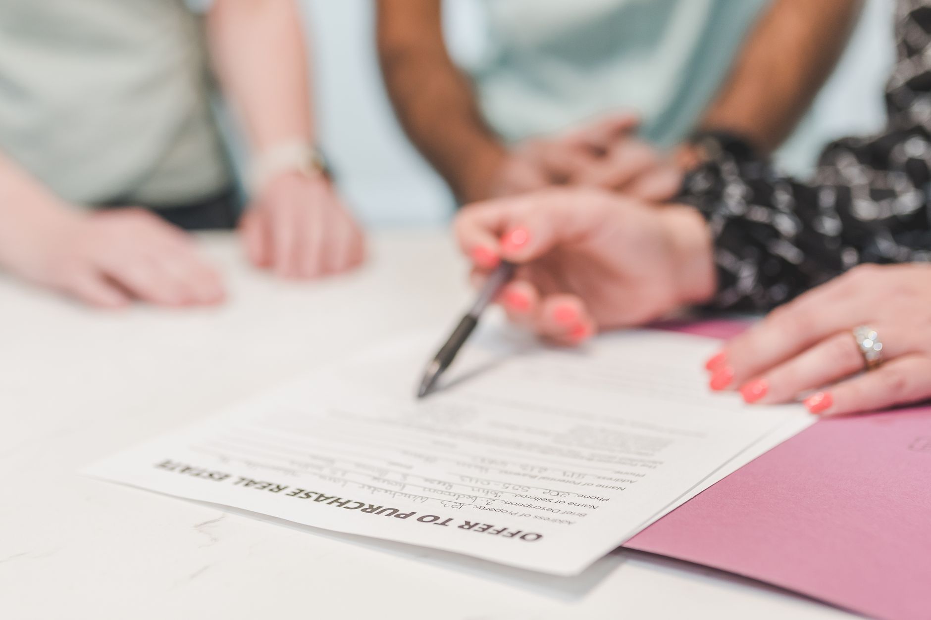 Luxury home buyer reviewing a purchase contract with a real estate broker