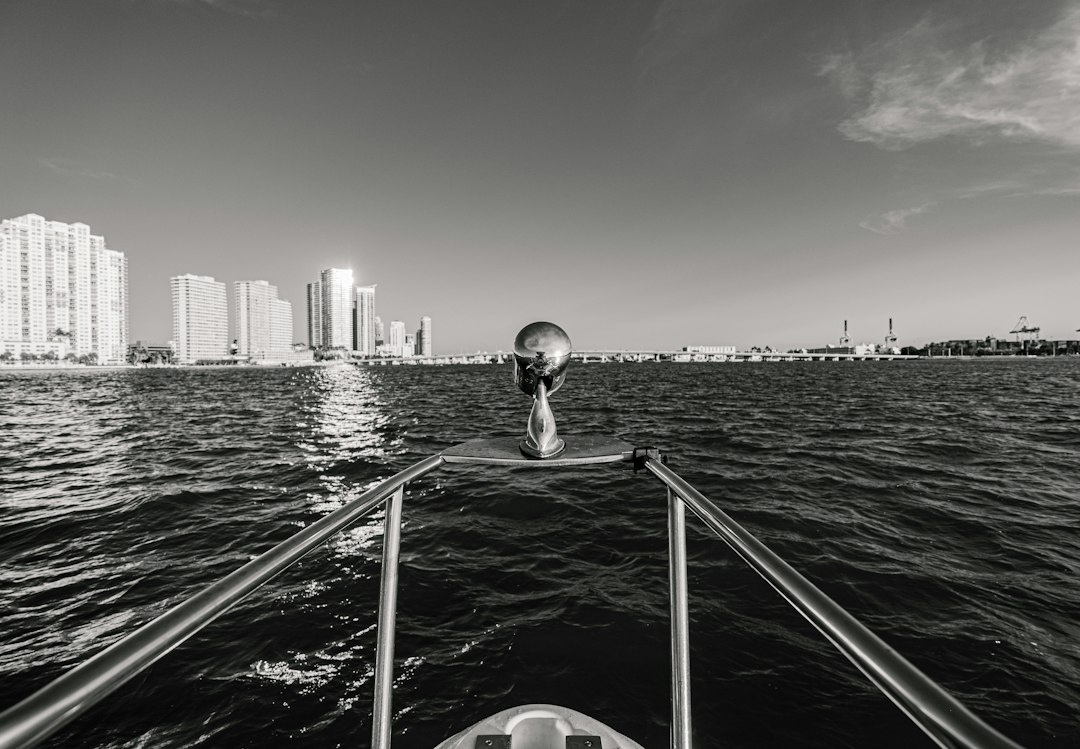 Surveyor measuring ground elevation at a luxury Florida waterfront home for an elevation certificate